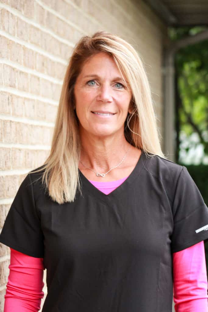 Wendee, Dhingras Expanded Functions Dental Assistant, who is wearing black and pink scrubs