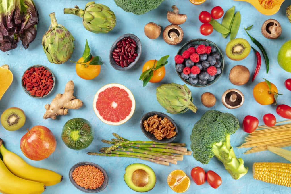 a topview of a table with lots of different fruits and veggies on top