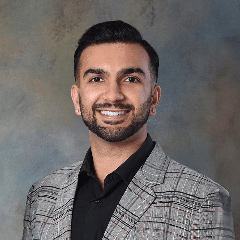 Springfield, Beavercreek, and Bellefontaine Ohio orthodontist Dr. Azie Dhingra in a gray blazer